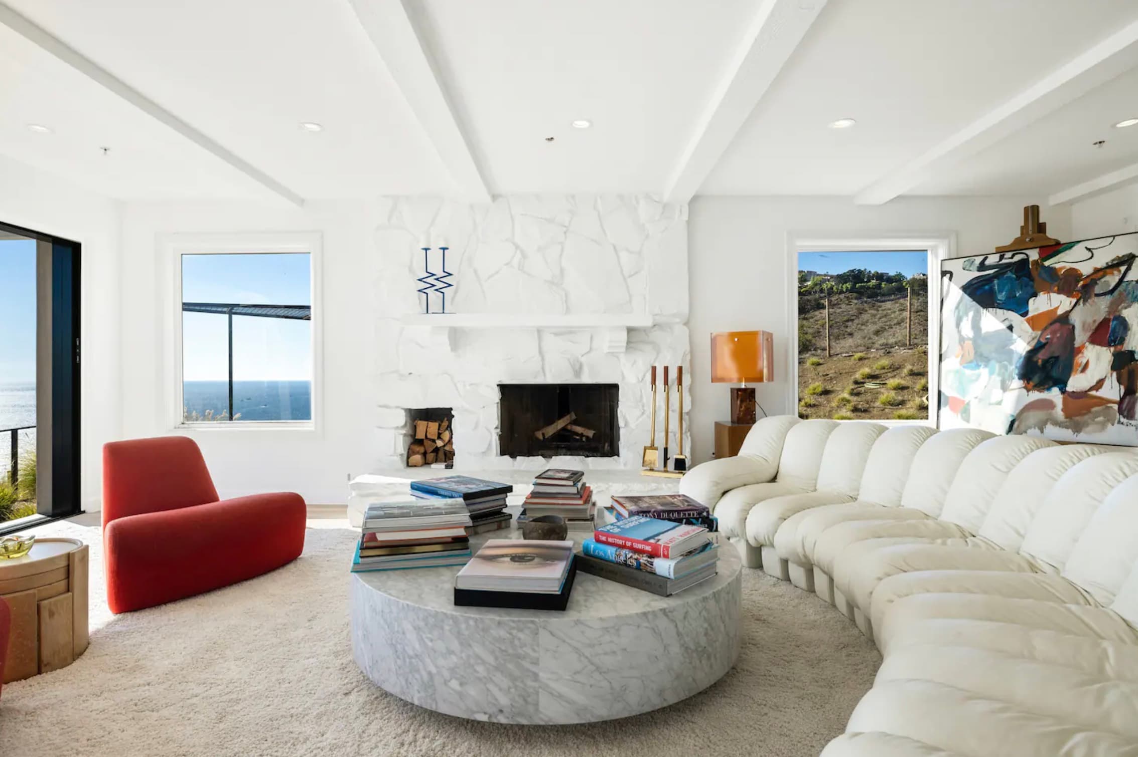 witness locations fletchers beach house zuma beach malibu living room white sectional red chair fireplace