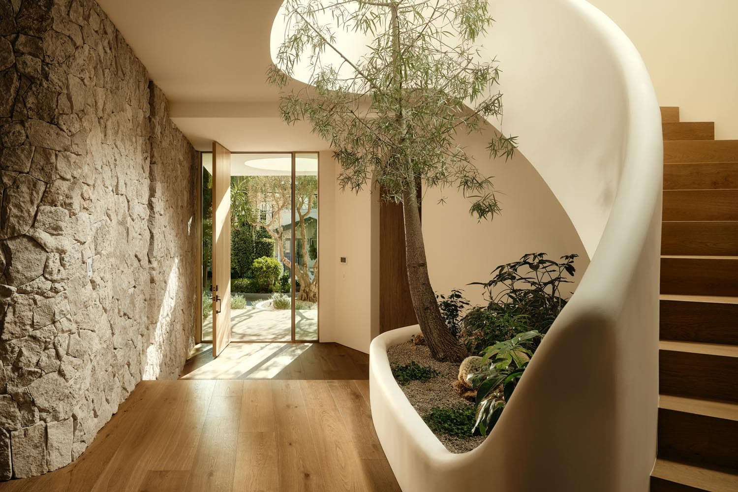witness locations goodland blanc studio city los angeles entry hall stone wall pivot door spiral stair planter