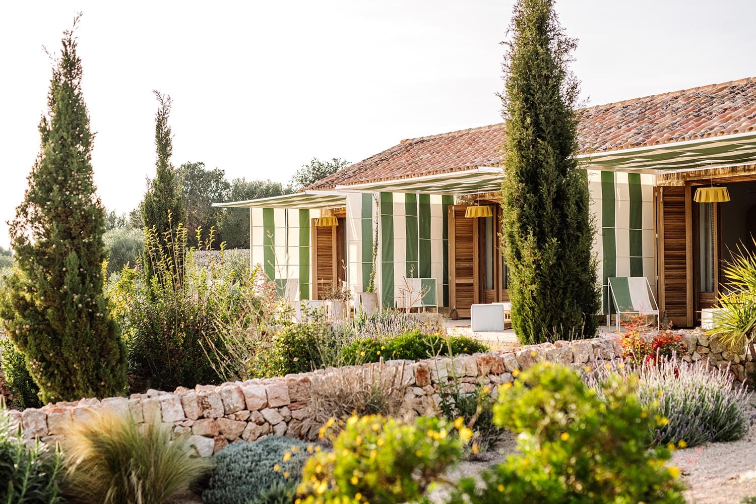 witness locations hotel amagatay menorca spain farmhouse facade cypress garden golden light