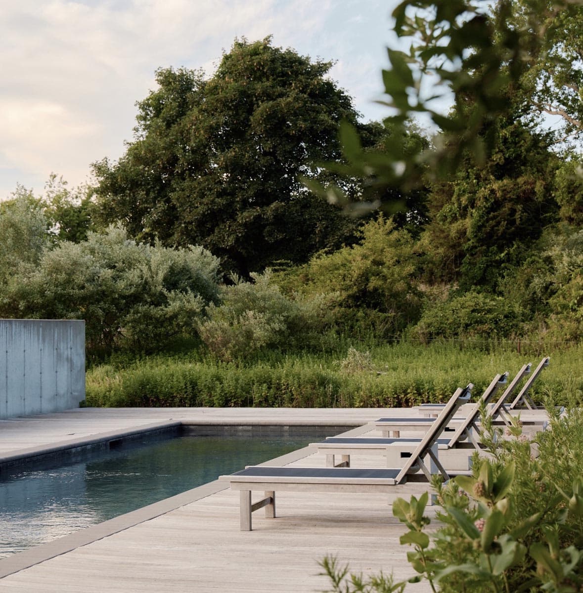 witness locations fieldhouse bridgehampton new york pool deck loungers meadow trees