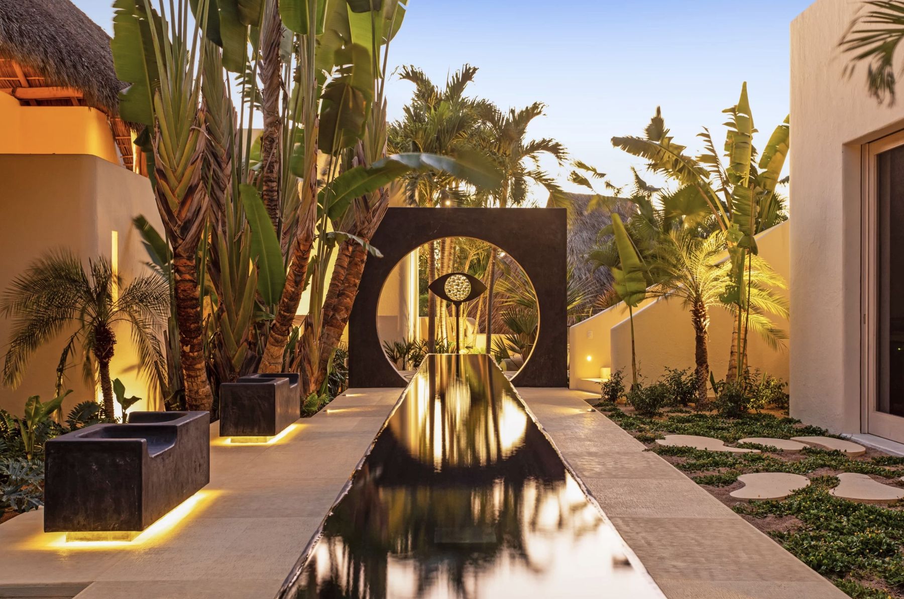 Moon gate and reflecting pool lit at dusk at the entrance to Casa La Huerta, Careyes, Mexico