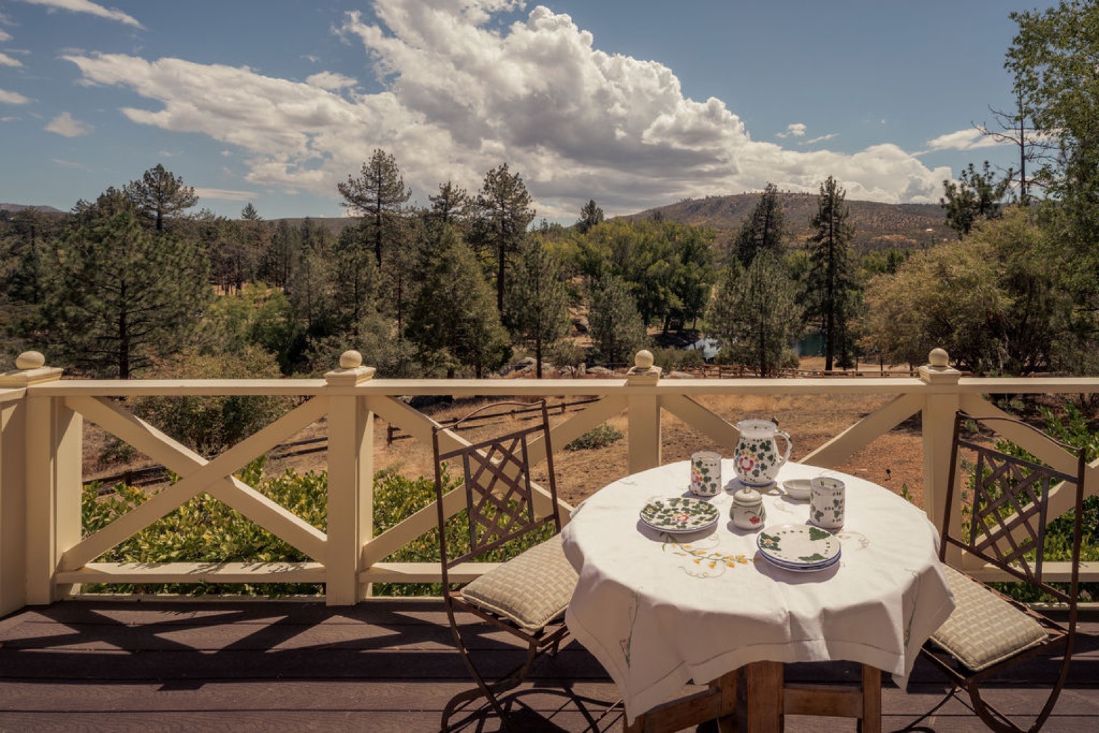Breakfast table on the Chalet Tournesol balcony deck above the pine forest and San Jacinto foothills
