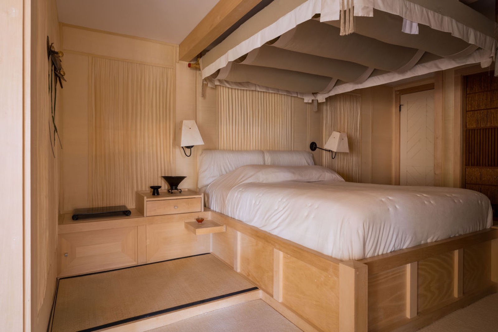 Japanese suite with a maple platform bed beneath a silk canopy and a tatami step