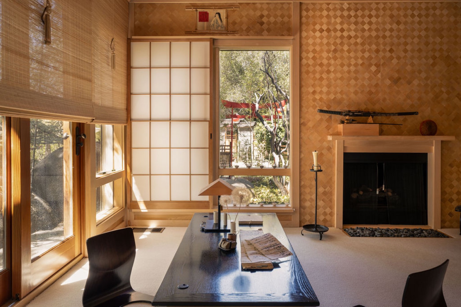 Japanese sitting room with a black lacquer desk and a shoji window framing a red torii gate