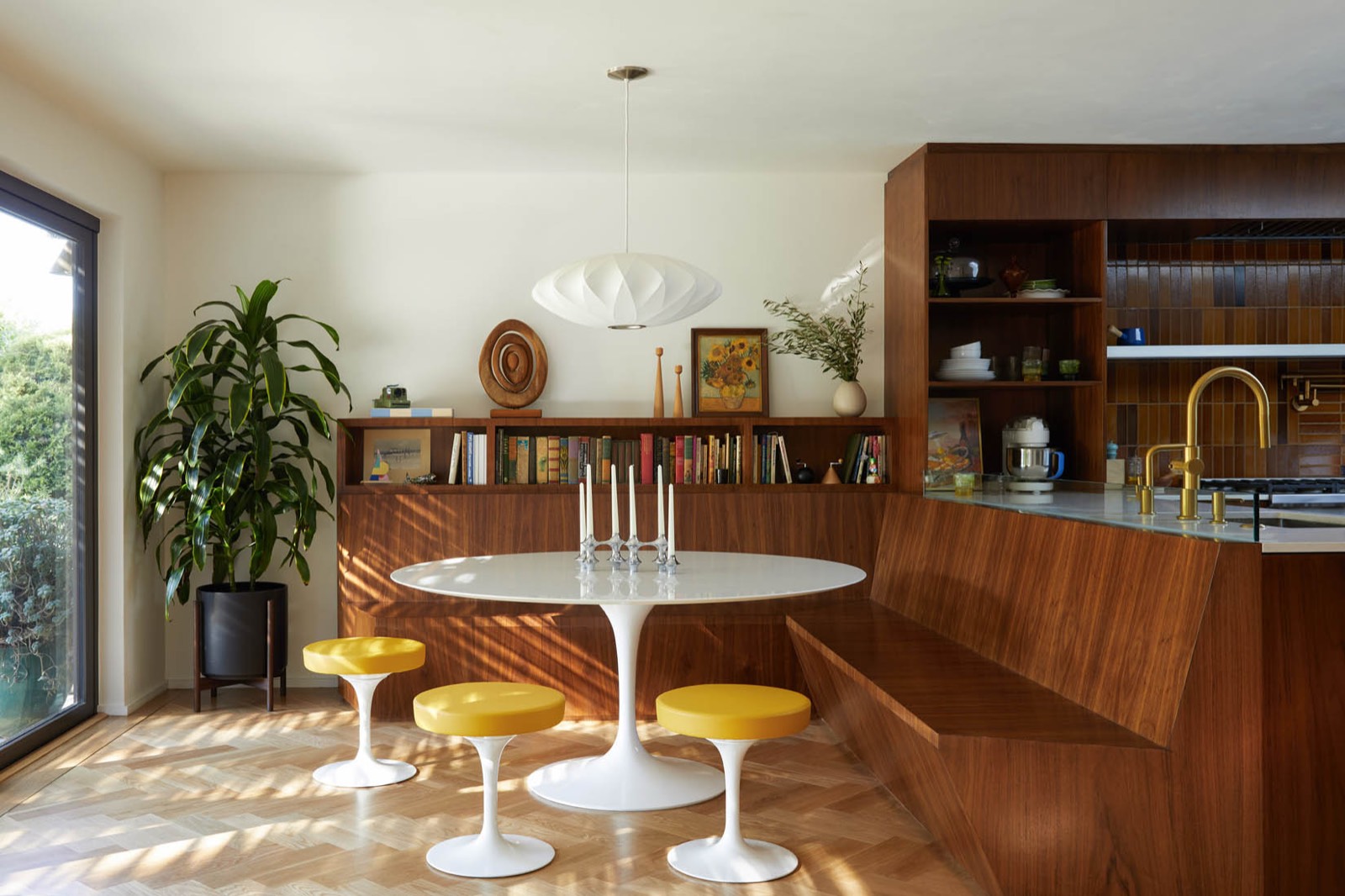 Merck House kitchen with walnut millwork and a tulip table