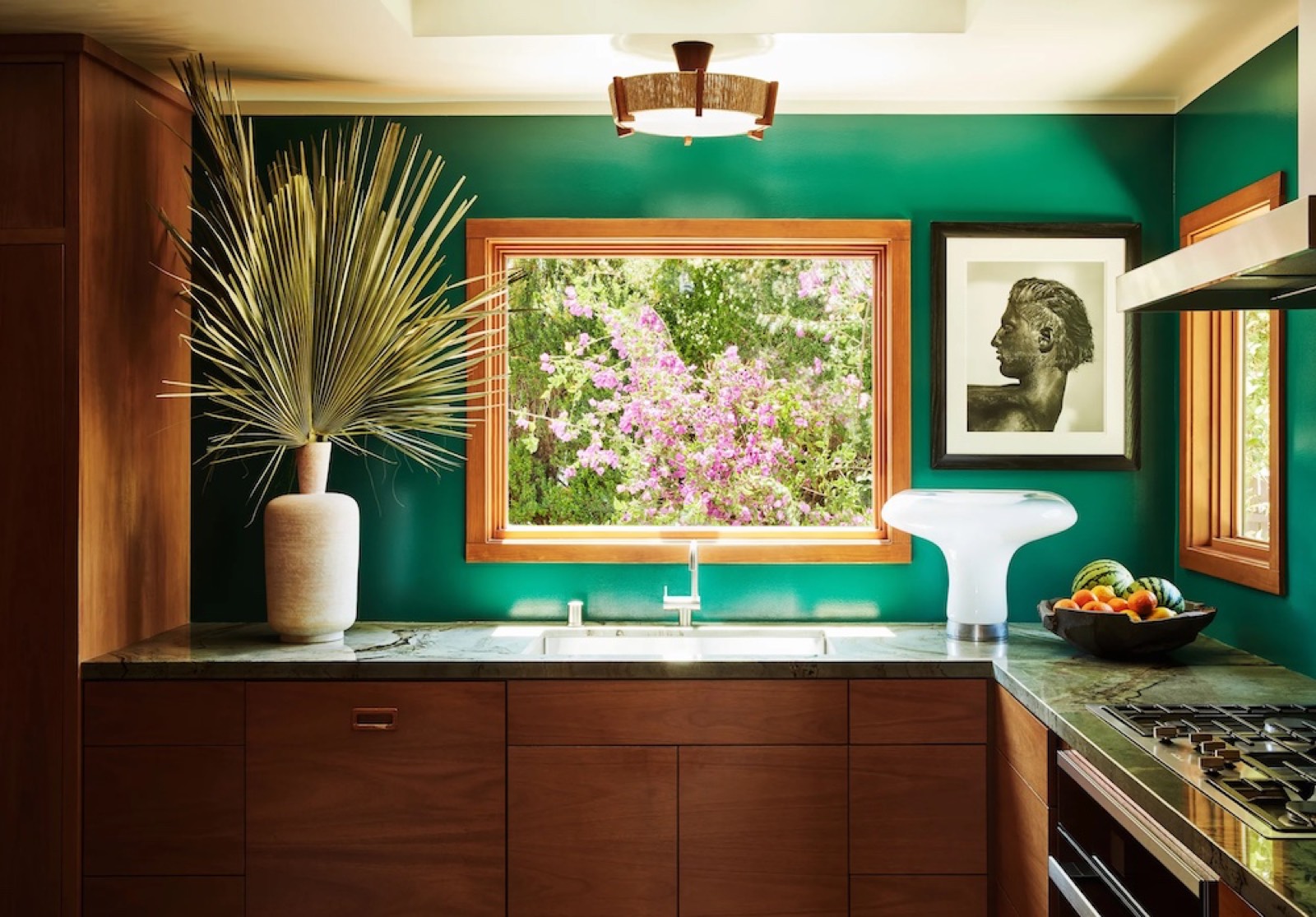 Emerald green kitchen with walnut cabinetry at Milano House