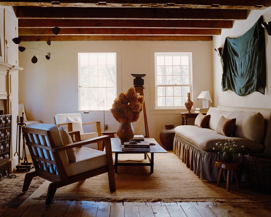 Warm, sunlit living room with timber beams