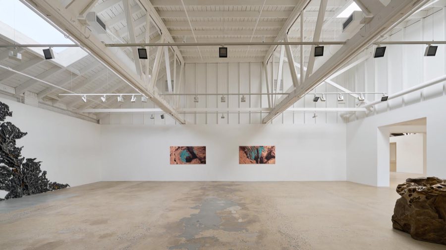 Main gallery with skylights, white steel trusses and a concrete floor at Seward Gallery, Hollywood