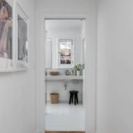Contemporary bathroom with wall-mounted sink and storage