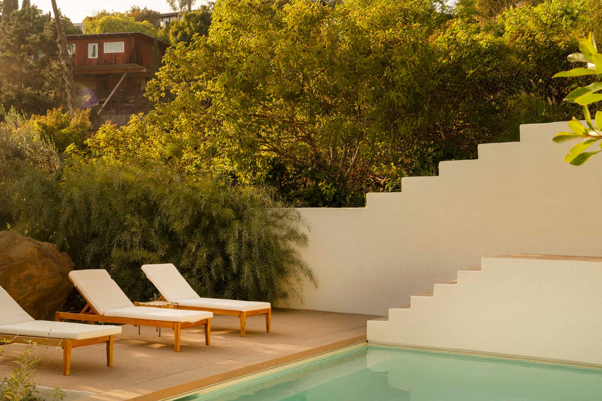 Secluded villa with stucco walls, terraced garden, and panoramic canyon setting.