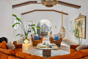 Casa Leona living space with rustic ceiling beams, classic décor, and warm natural lighting