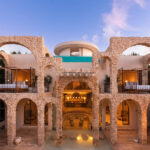 Stone archways surrounding the pool at Casa Arka