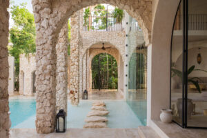 Arched facade opening to a turquoise pool